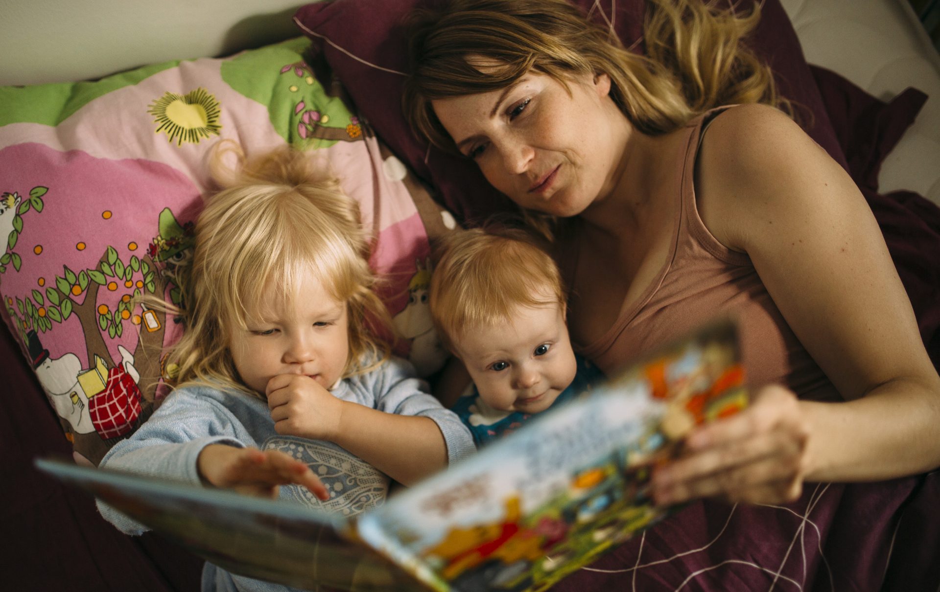 En mamma läser för sina barn.